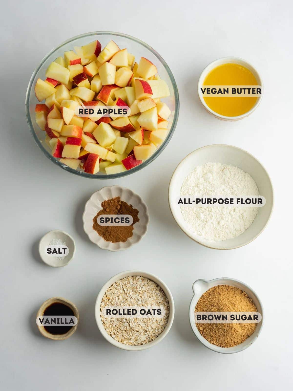 ingredients for apple crisp measured out in bowls.