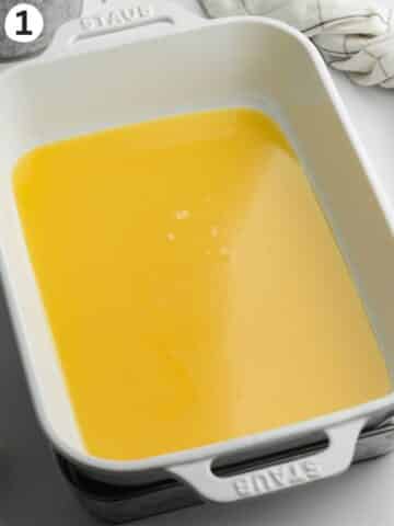 sweetened condensed coconut milk in a staub pan on top of a water bath.