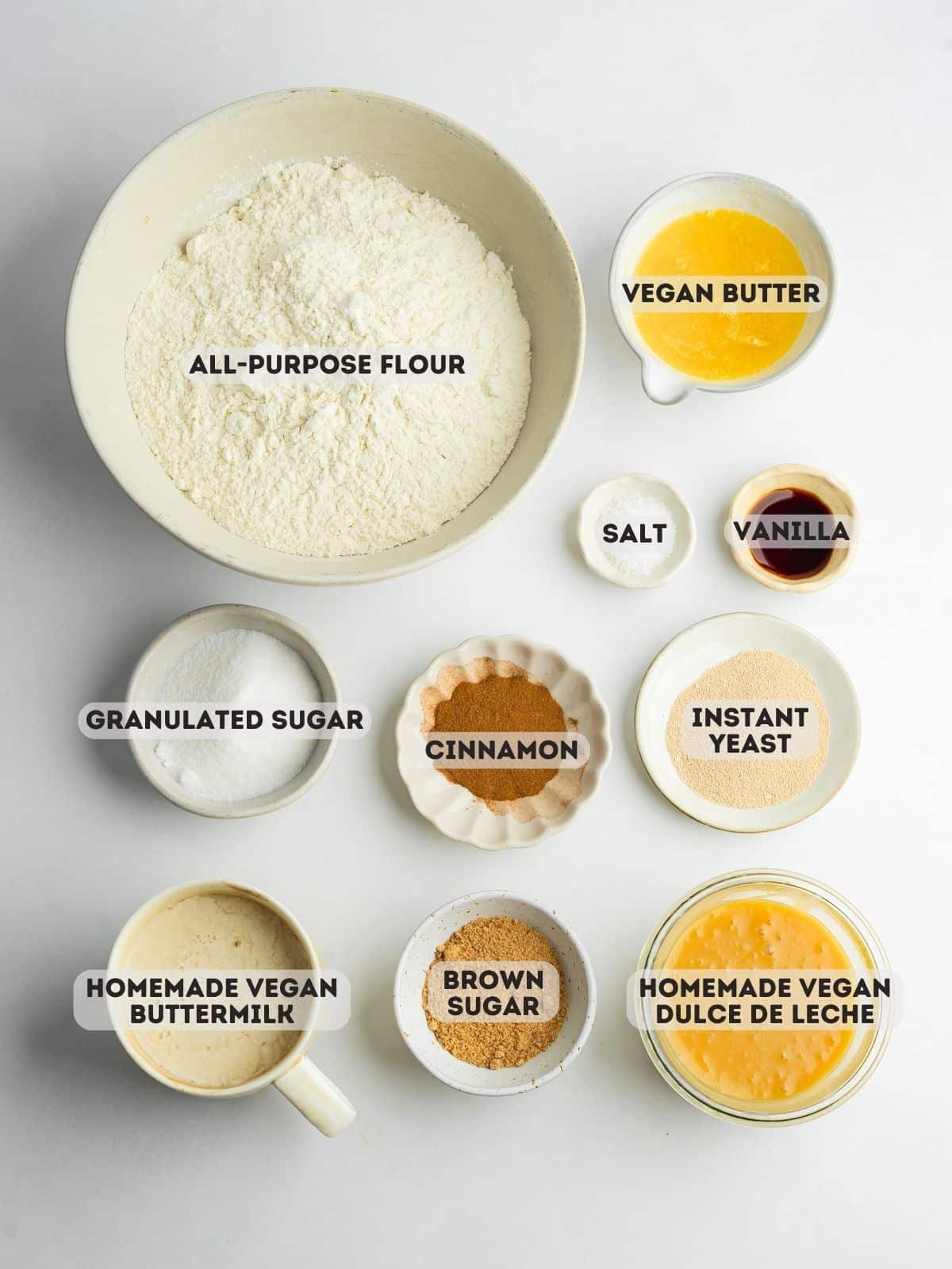 cinnamon roll ingredients measured out in bowls.