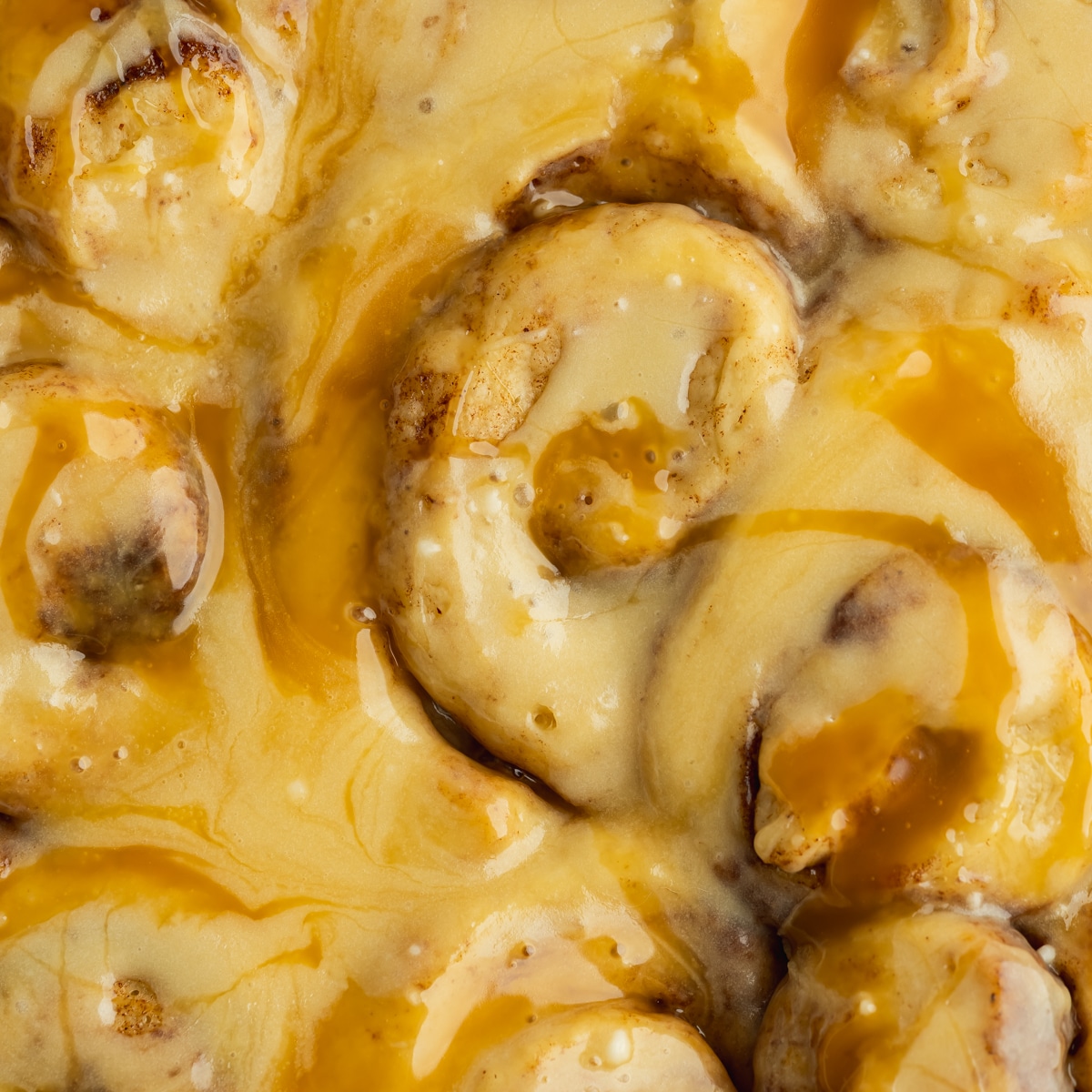 a closeup of cinnamon rolls with dulce de leche swirled throughout.